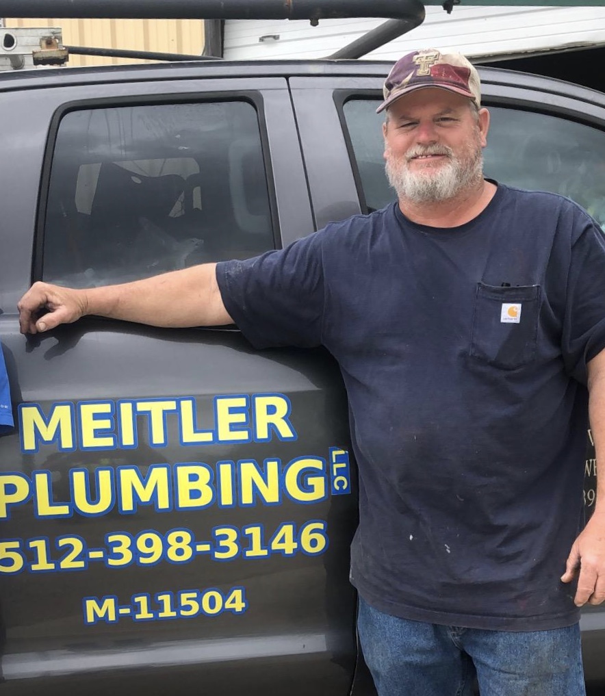 Darin Meitler, Licensed Master Plumber, standing by his work truck in Lockhart, TX